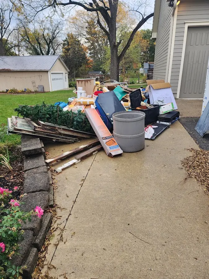 Dumpster being loaded with debris for Roofing Dumpster Rental in Bessemer City